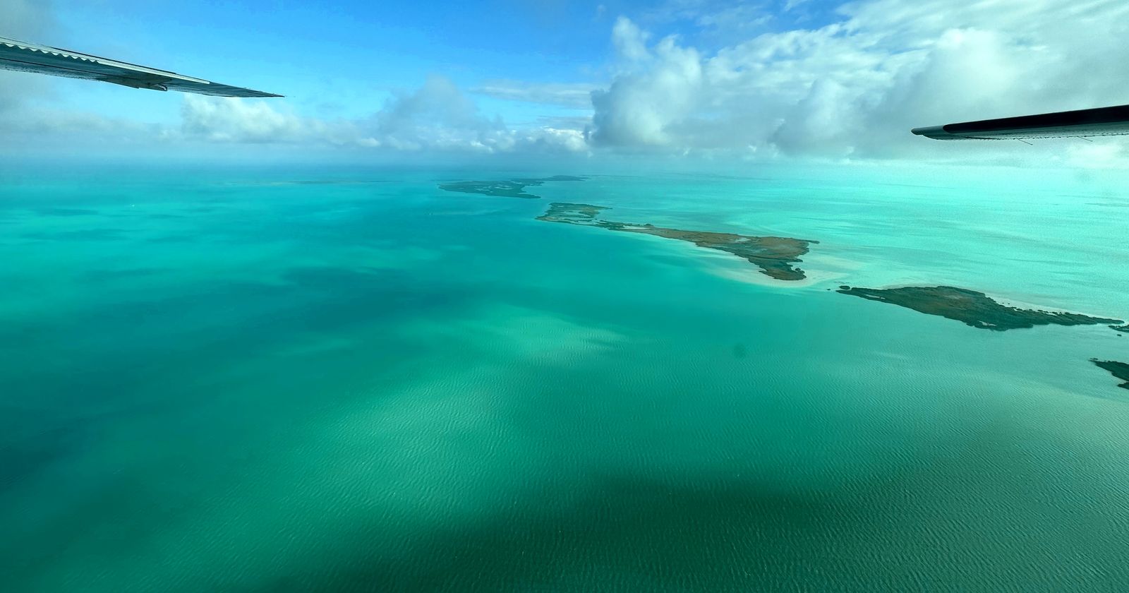 Turquoise water, reef and cayes of Belize seen from a small plane