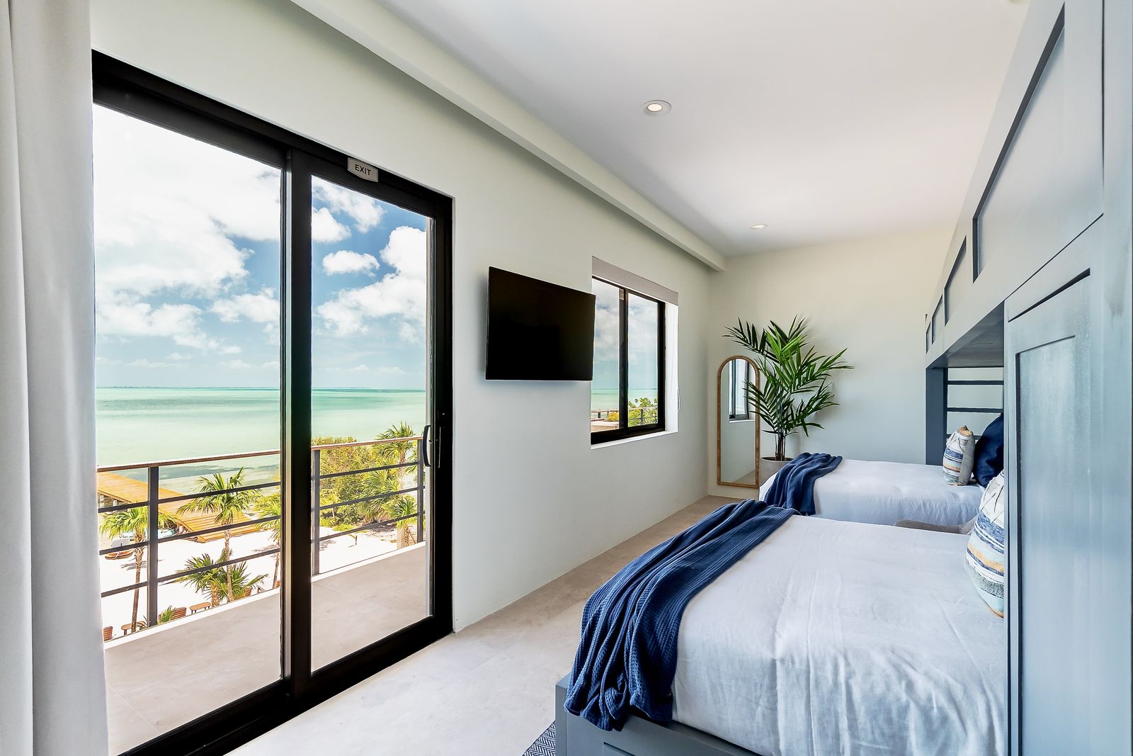 The bunk room's balcony doors and sea view