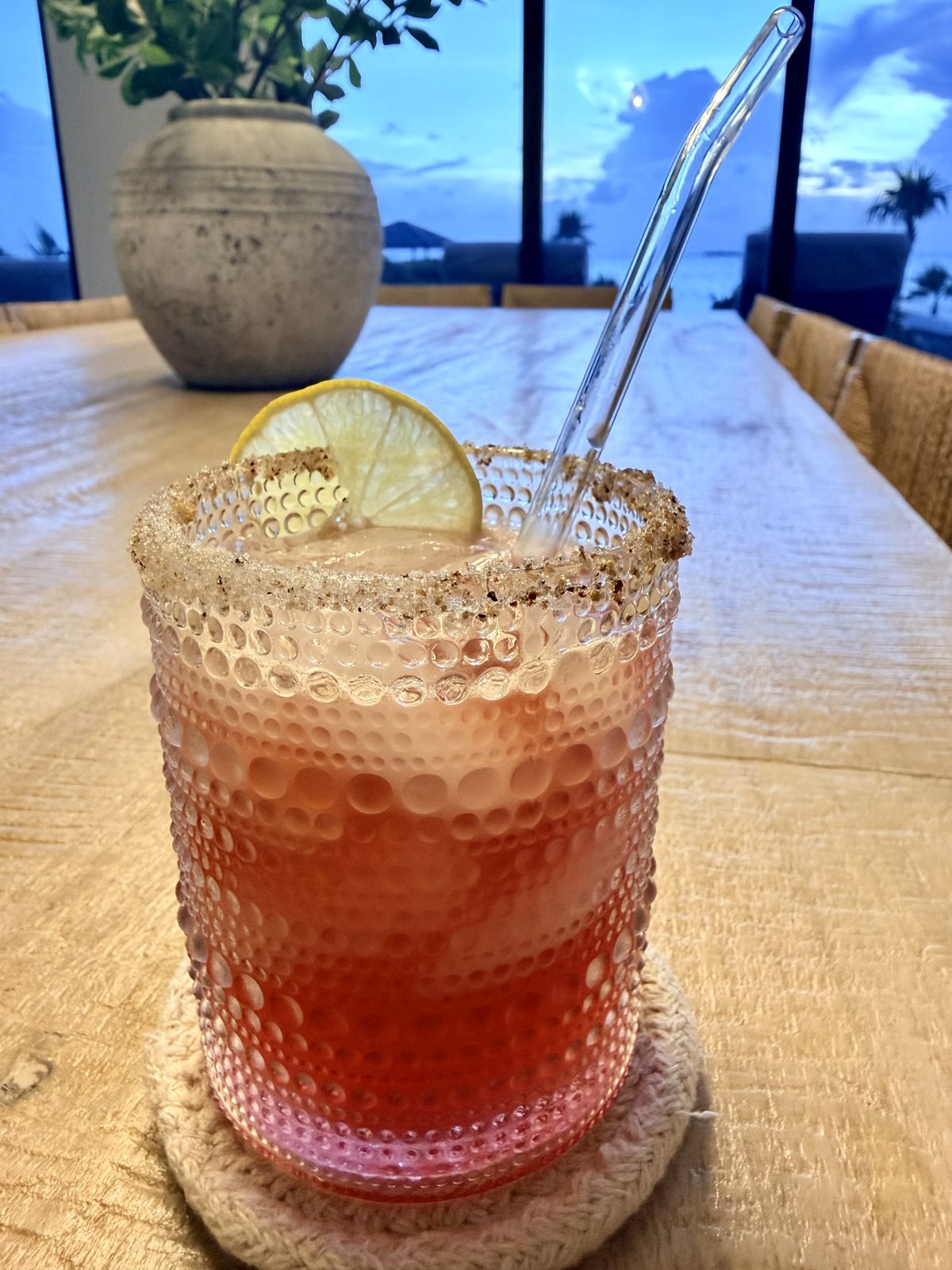 A cocktail with a salted rim and a slice of lime, mixed by Everaldo at the villa bar