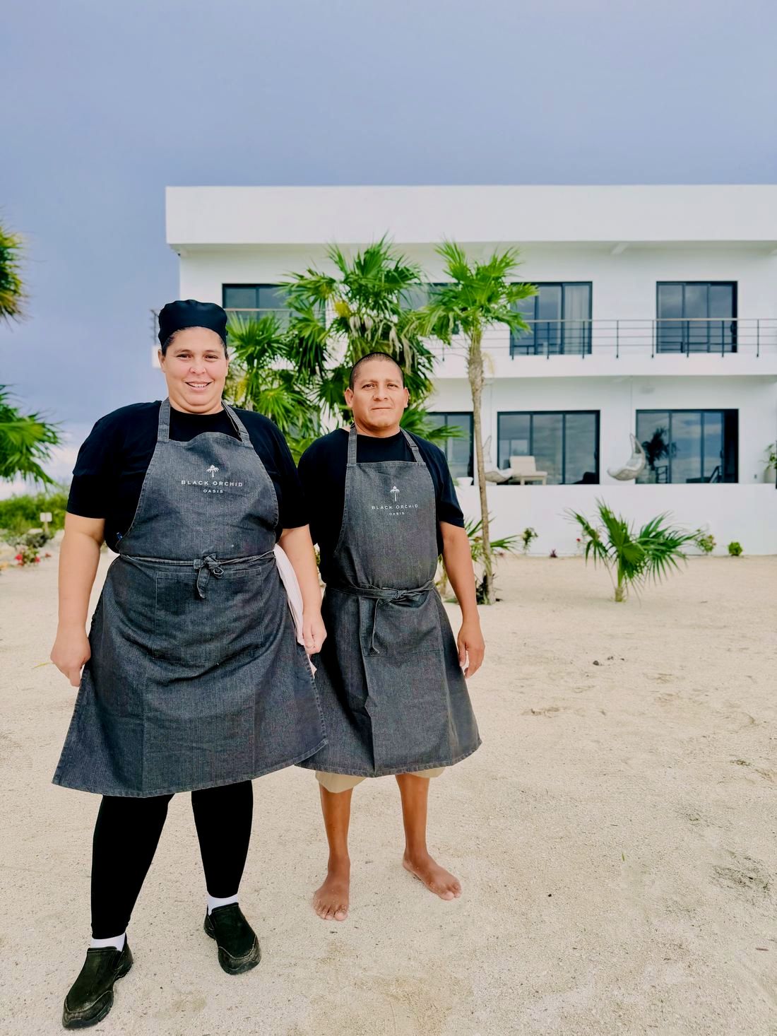Delma and Everaldo, the villa's private chef and bartender, in front of Black Orchid Oasis