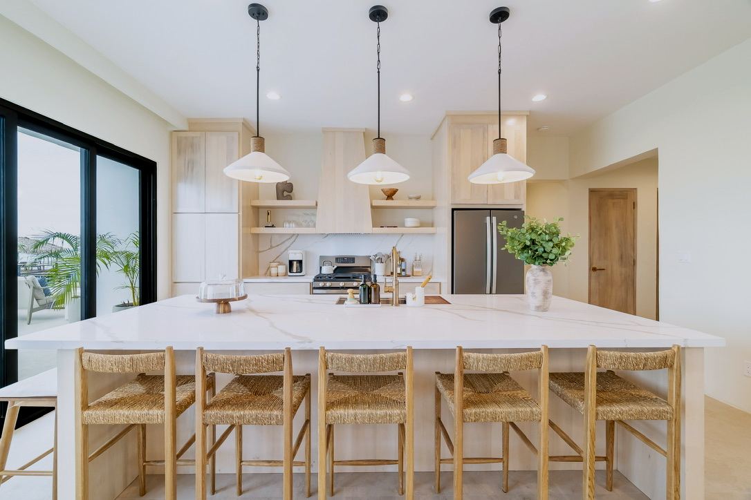 The kitchen island with seating and pendant lights