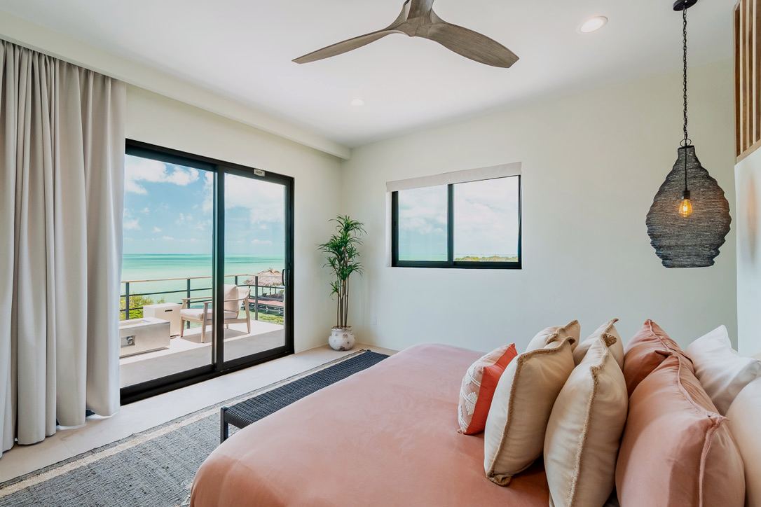 The Orchid Suite: a second-floor king with a balcony over the pool and the sea