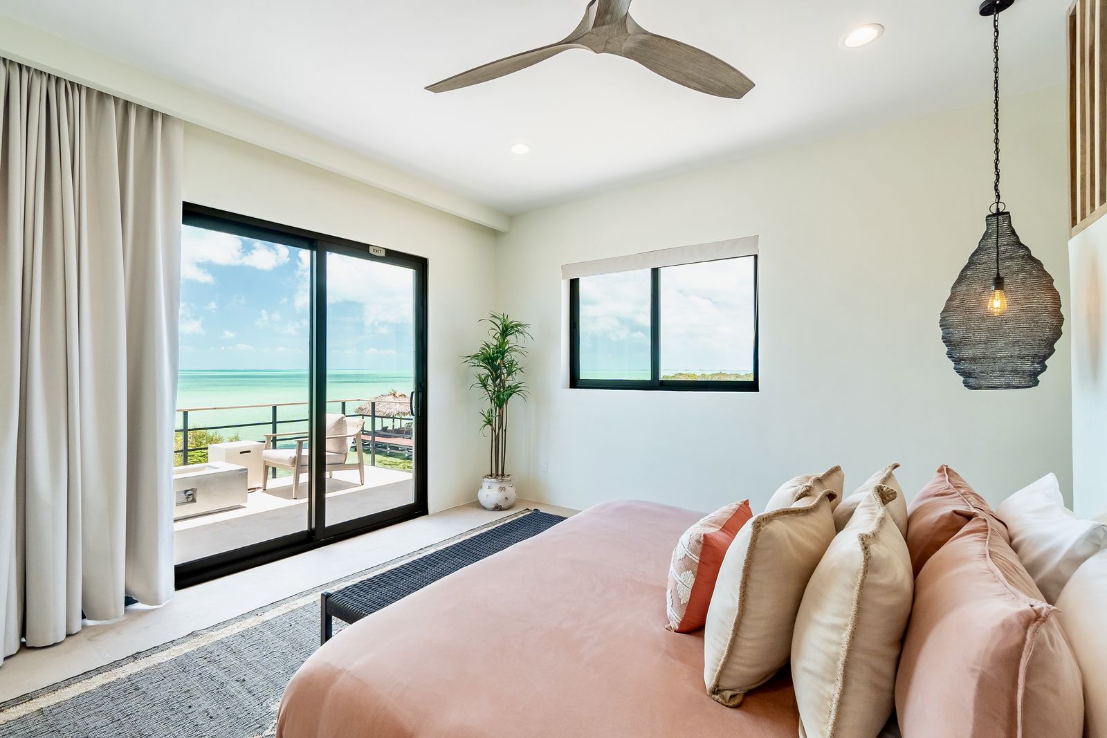 The Orchid Suite: second-floor king with a private balcony over the pool and the sea