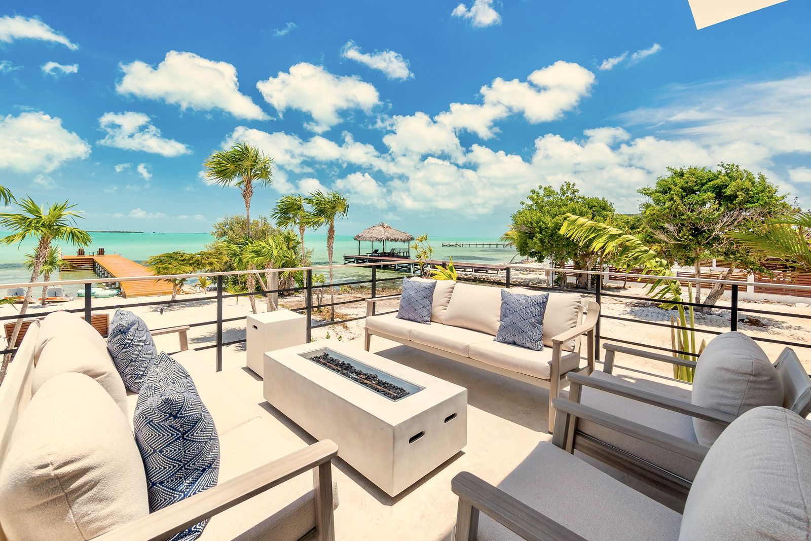 Upper terrace lounge with fire tables overlooking the dock and the water